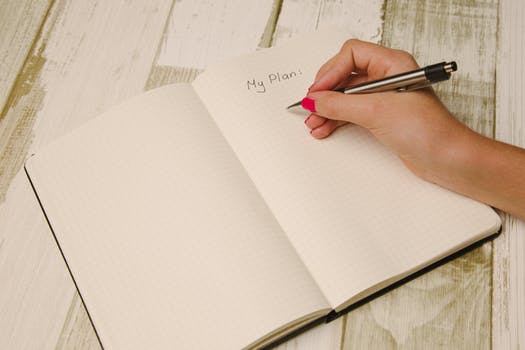 image: woman writing to do list on pad